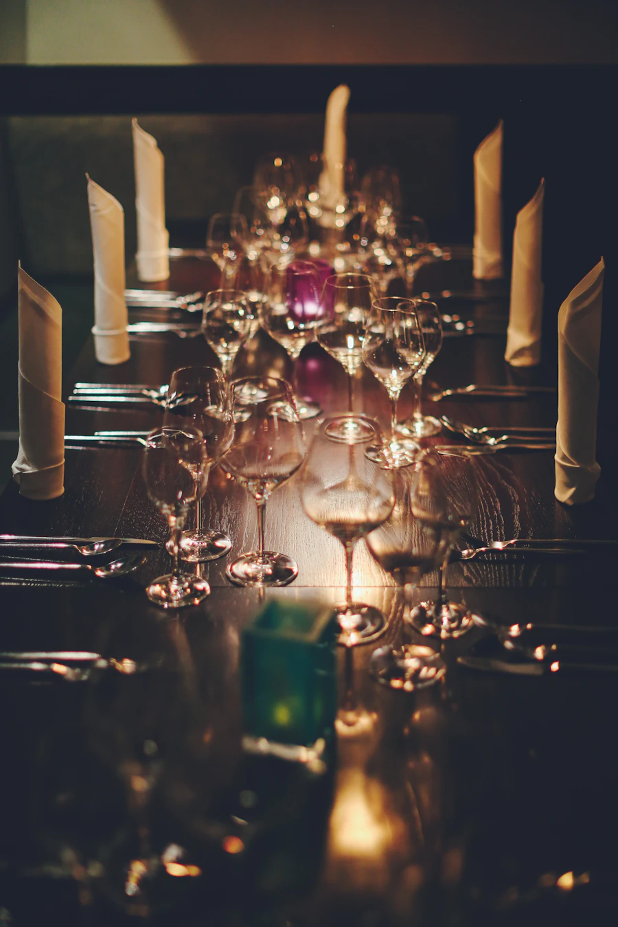 Long candlelit table laid for dinner
