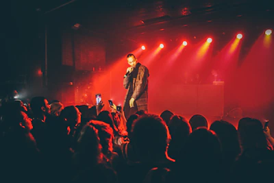 man singing in front of the crowd
