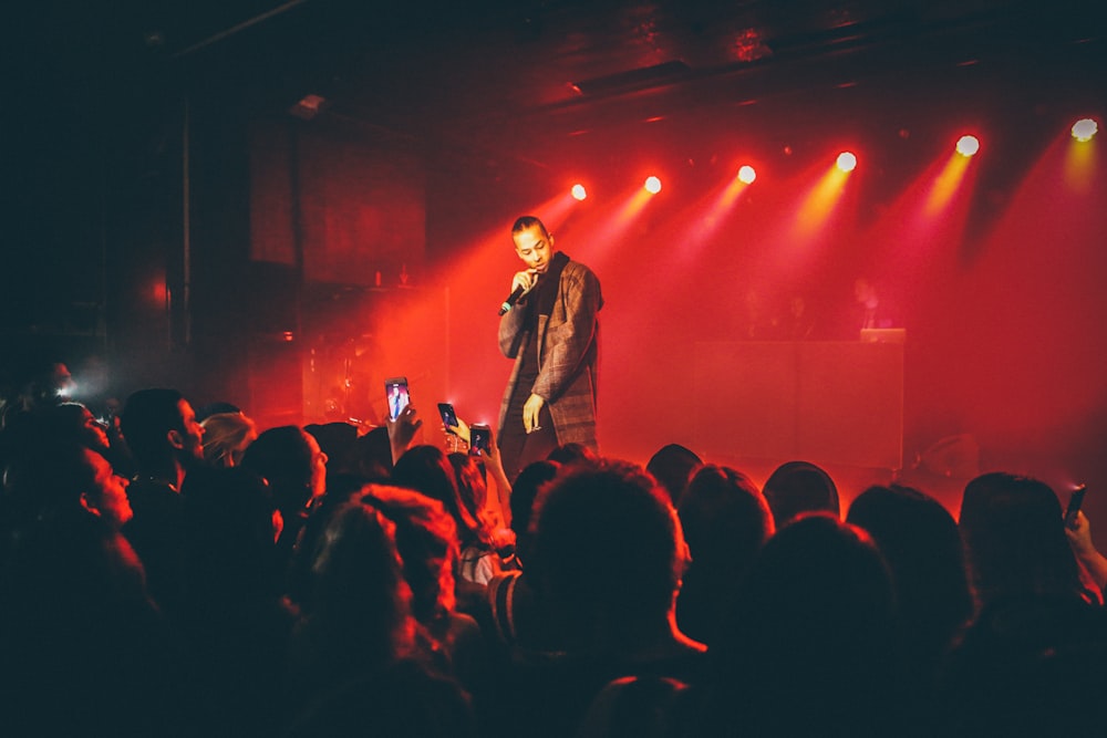 man singing in front of the crowd