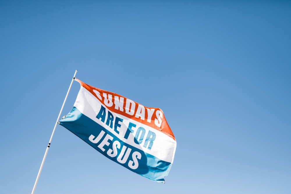 Sundays Are For Jesus flag on top of white flagpole