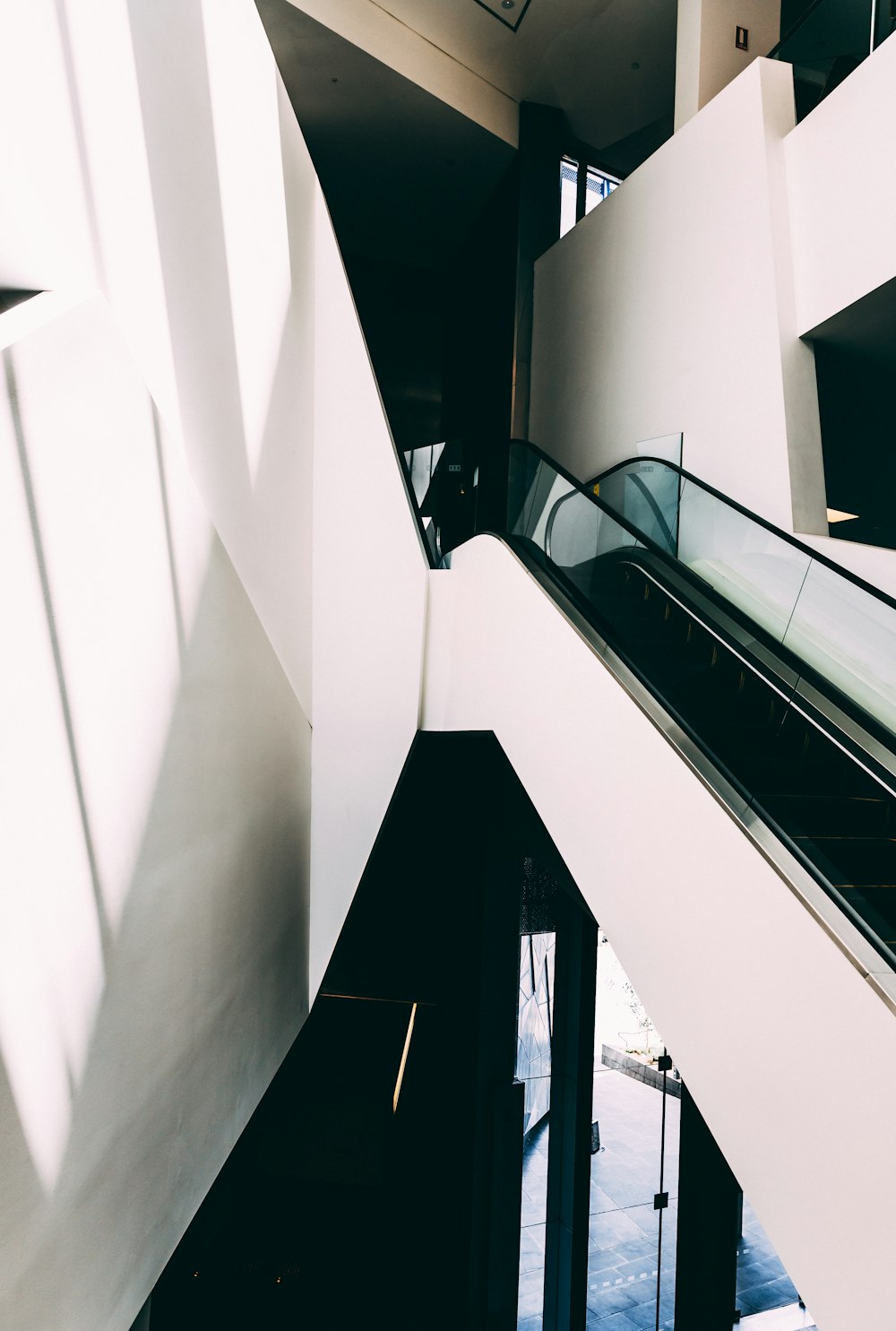 white and black escalator inside building