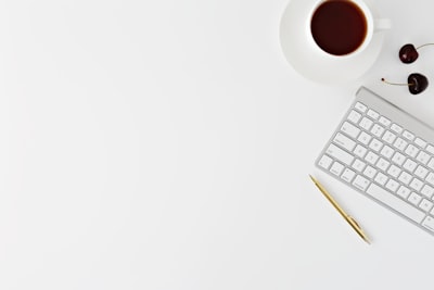 magic keyboard beside mug and click pen desk zoom background