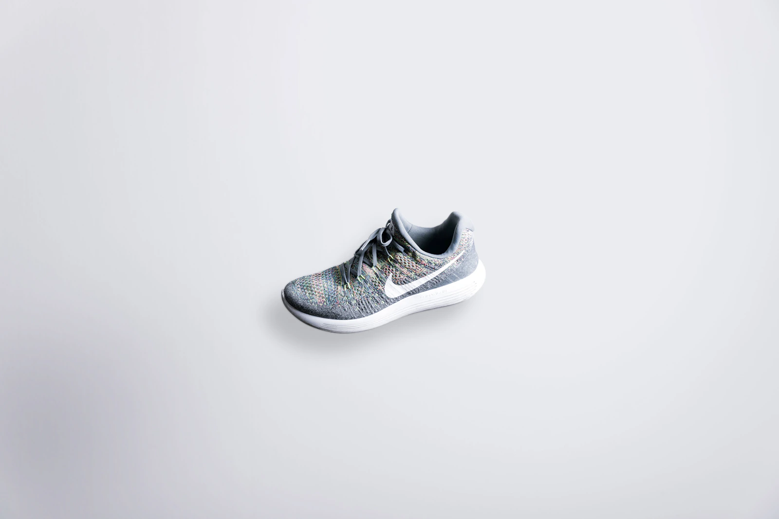 Grey Nike Flyknit running shoe on white