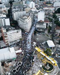 An aerial shot capturing a vibrant city event with crowds.