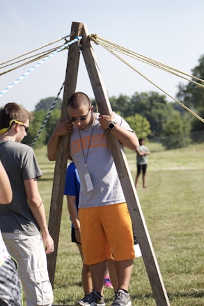 A group of coworkers engaged in an interactive team-building challenge outdoors.