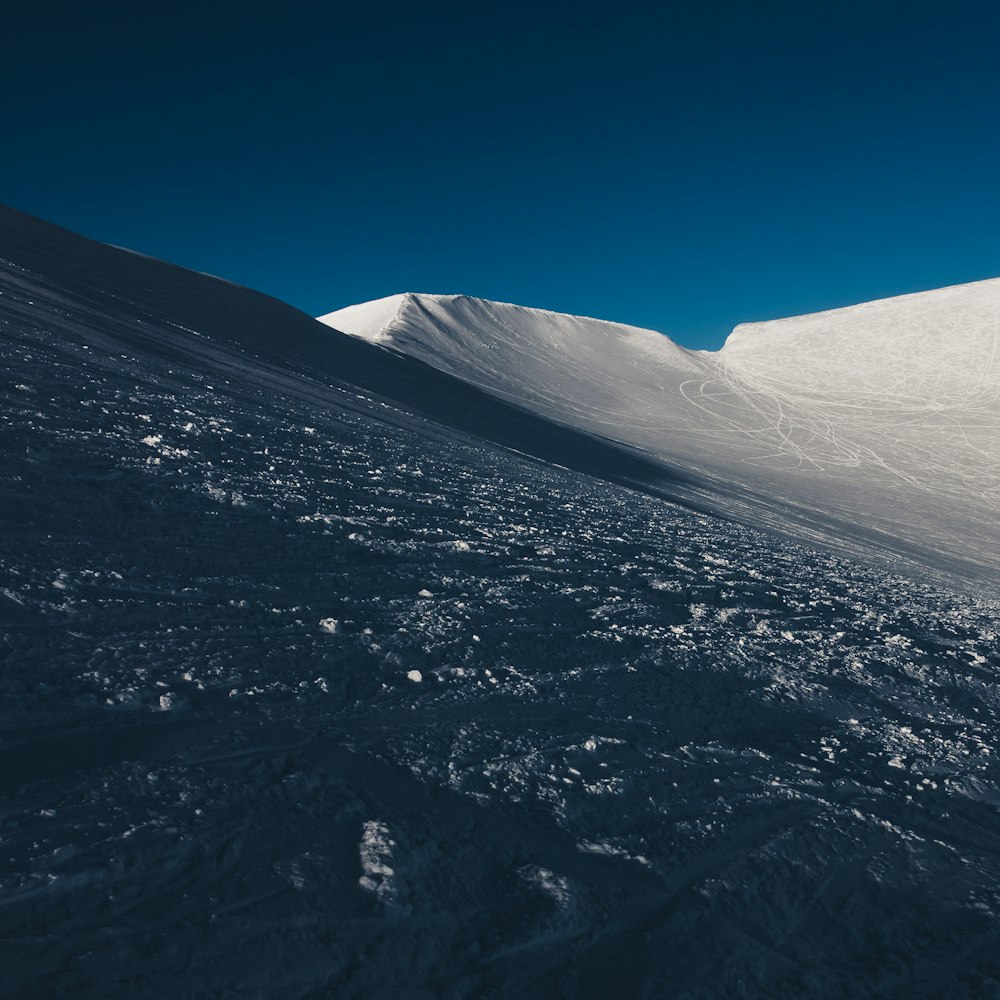 a man riding skis down a snow covered slope