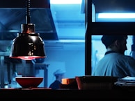 Futuristic kitchen with under-cabinet lighting casting amber hues that pulse gently.