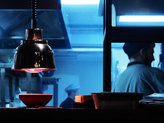 Futuristic kitchen with under-cabinet lighting casting amber hues that pulse gently.