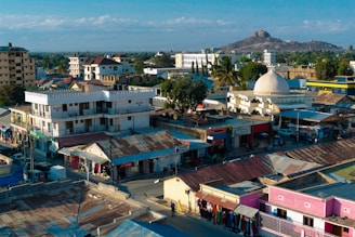 A vibrant photo of Cotabato City's city hall with locals engaging in community activities nearby.