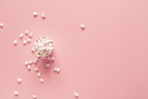 bunch of marshmallows on pink surfaceby Joanna Kosinska