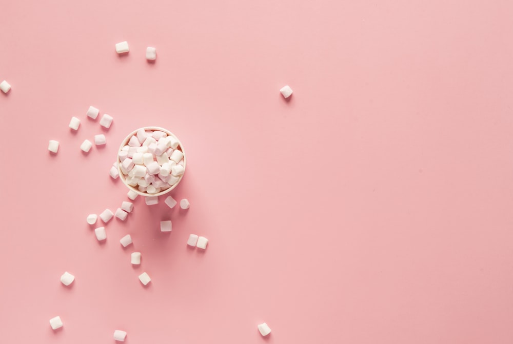 bunch of marshmallows on pink surface