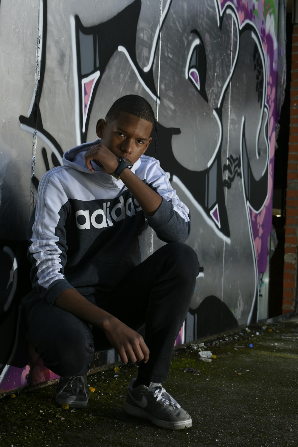 man leaning on painted wall