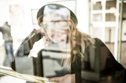 photo of woman leaning on brown table
