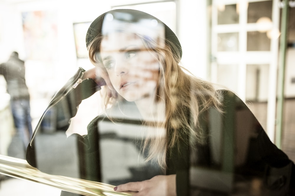 photo of woman leaning on brown table