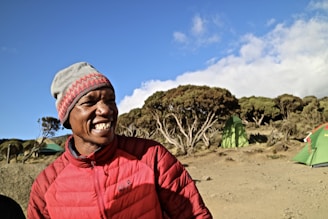 A cheerful camper holding a J&J RV Rentals giveaway flyer with bonus points icons floating around.