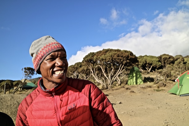 A cheerful camper holding a J&J RV Rentals giveaway flyer with bonus points icons floating around.