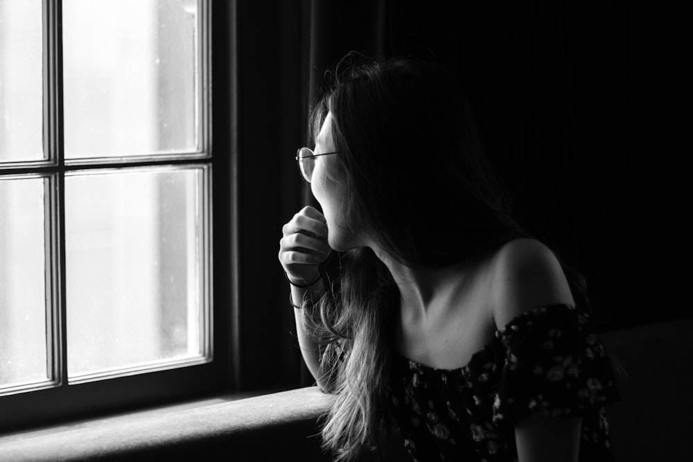 grayscale photo of woman in off-shoulder top