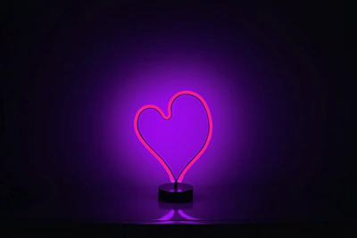 A glowing purple quantum heart symbol against a dark cosmic background.