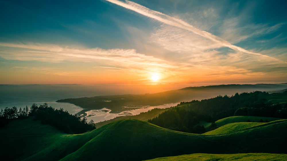 landscape photography of green mountains over the horizon