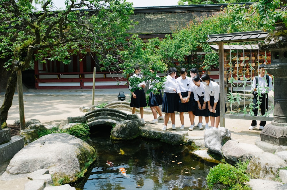 women looking into pond