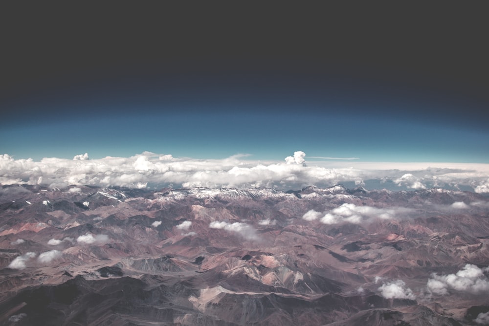 arial view of mountains with clouds