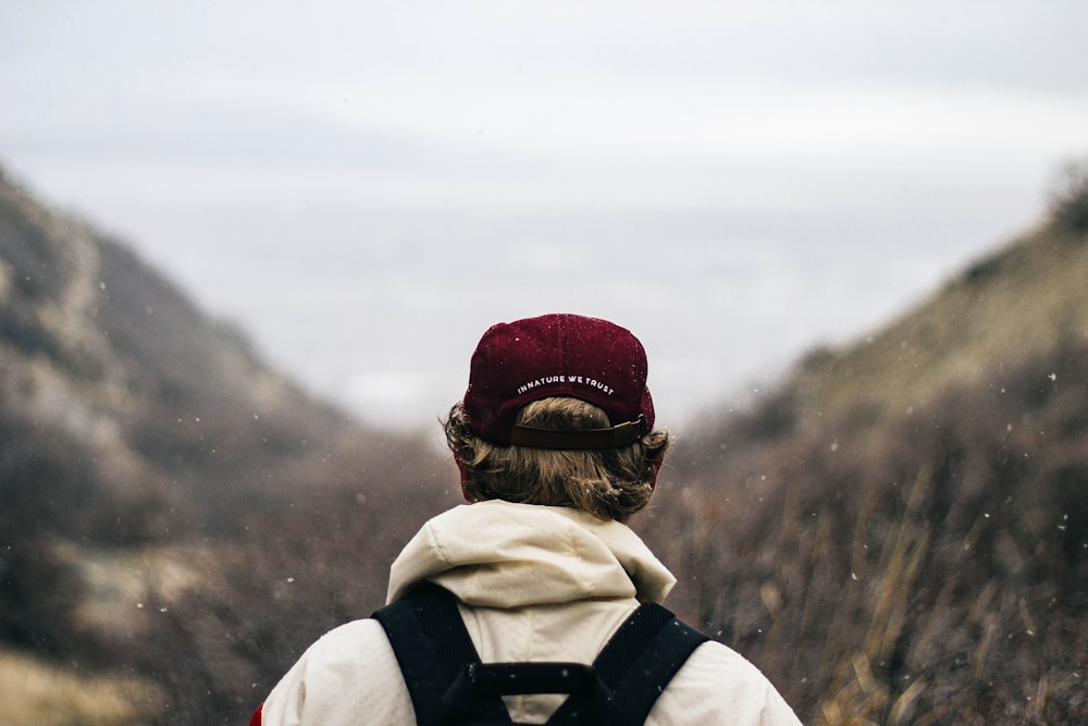 selective focus photography of person viewing mountains