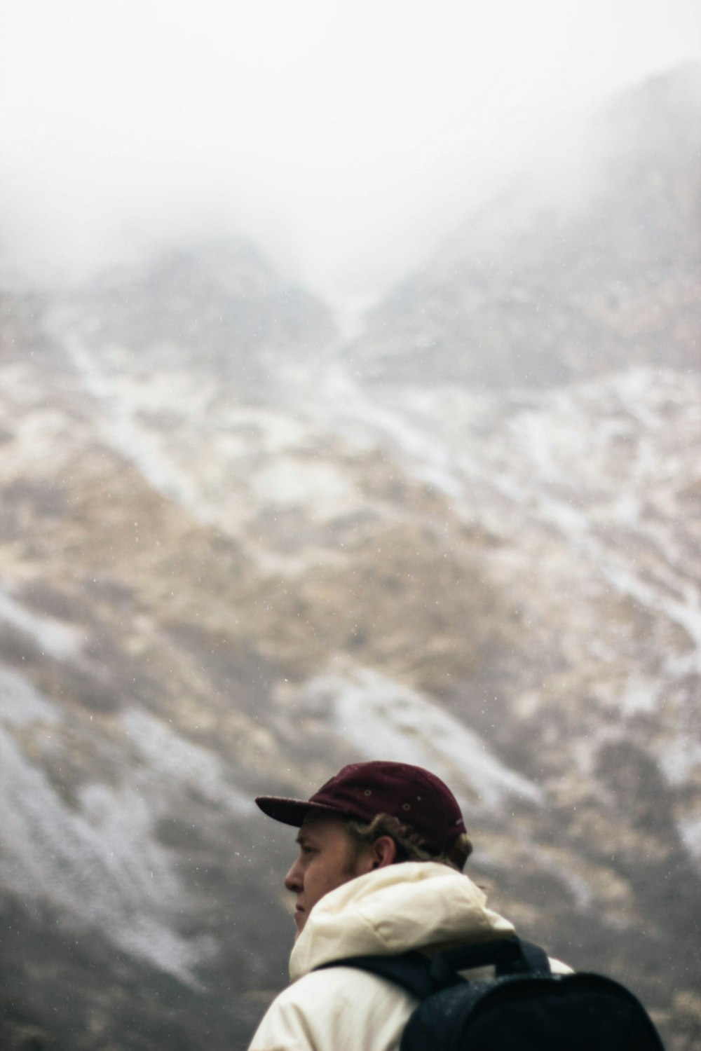 shallow focus photography of man carrying black backpack