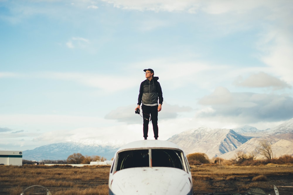 man standing top of the plane