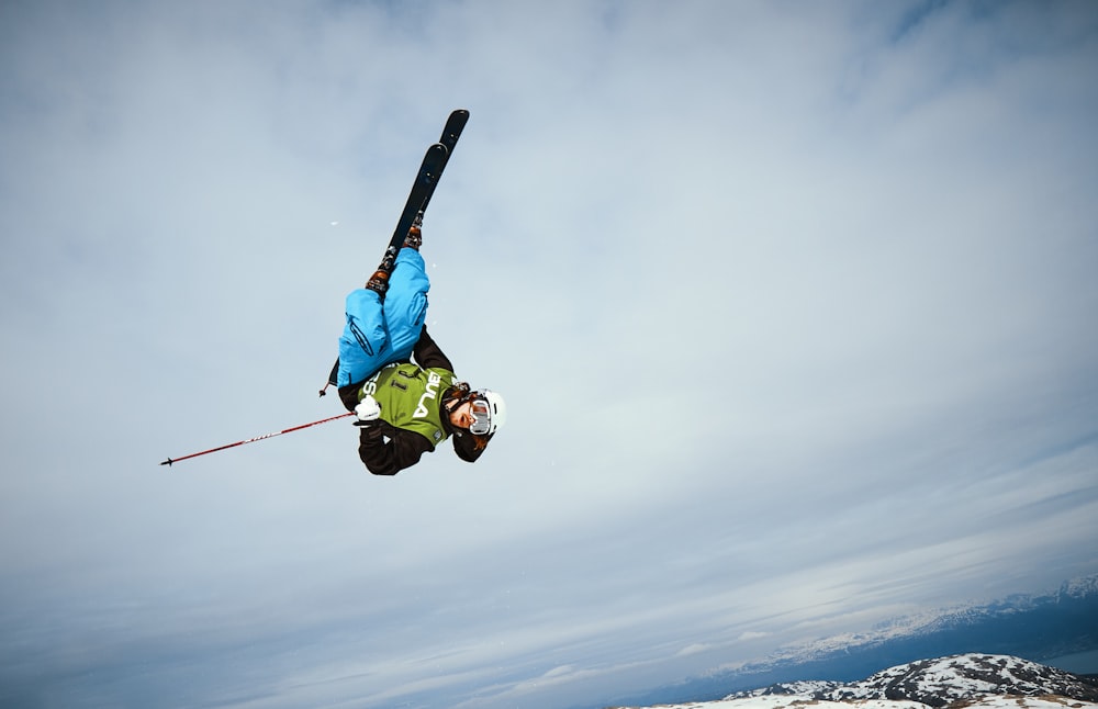 man doing ice skate trick mid air