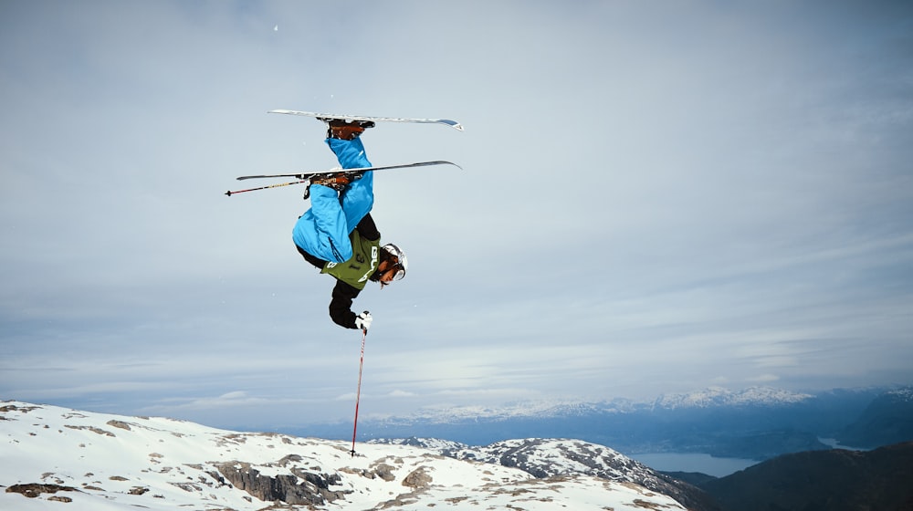 man snow ski holding pole