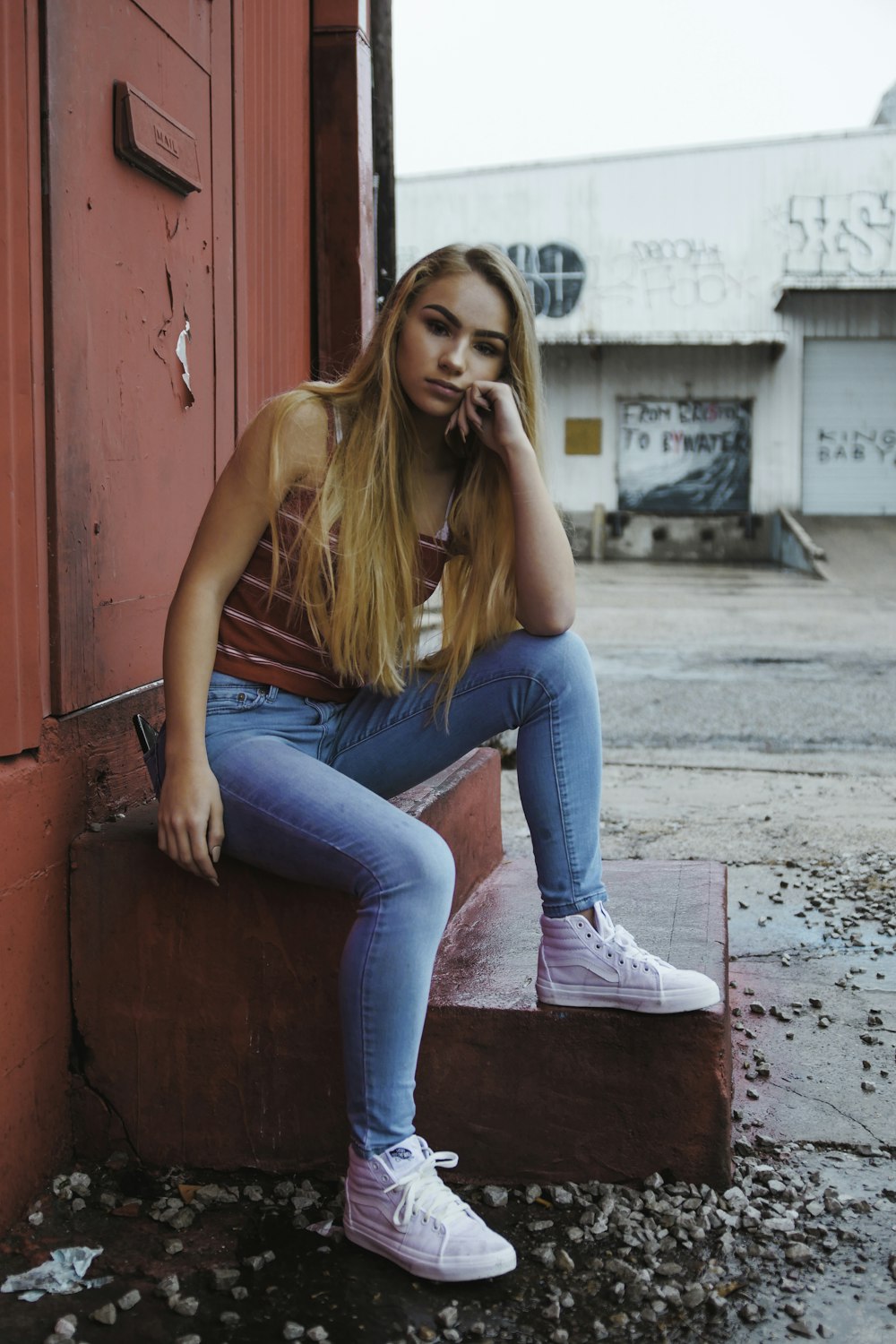 woman sitting on red stair