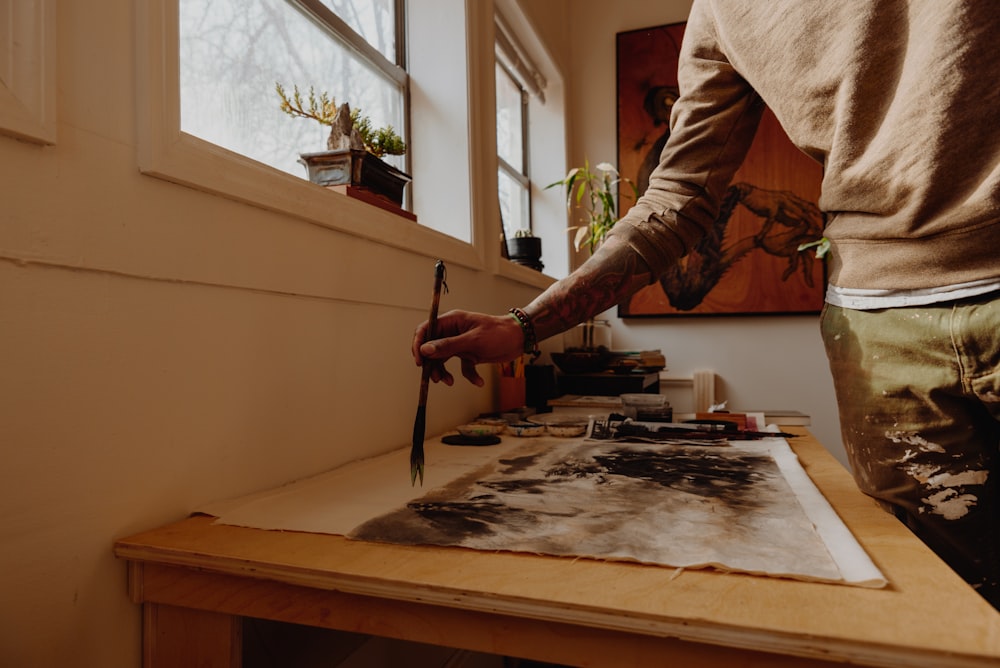 man painting on white canvas