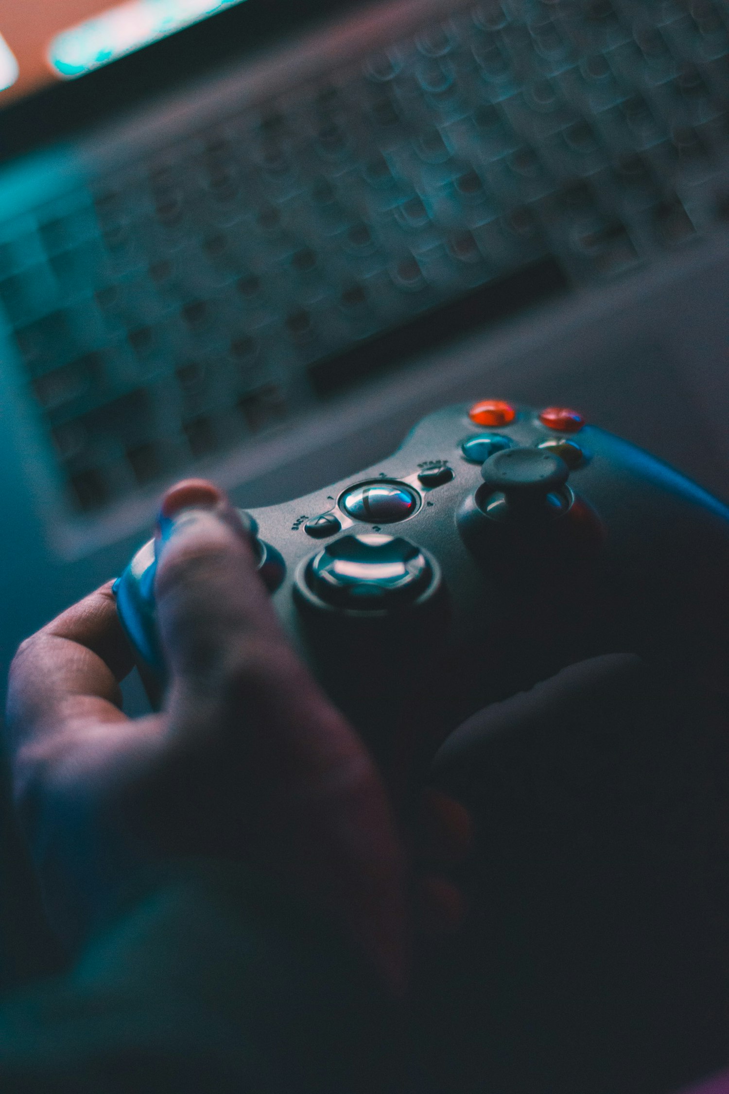 person holding black game controller by Hardik Sharma