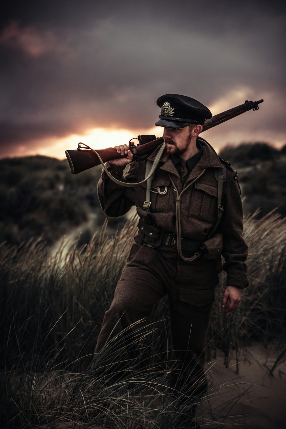 man carrying rifle outdoors