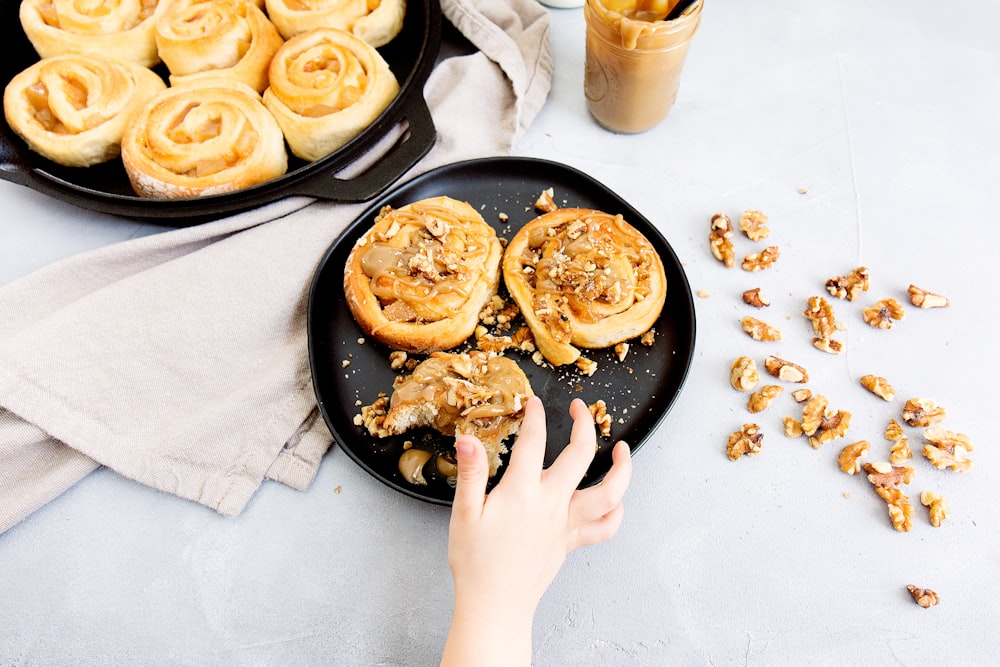 person holding pastry on plate