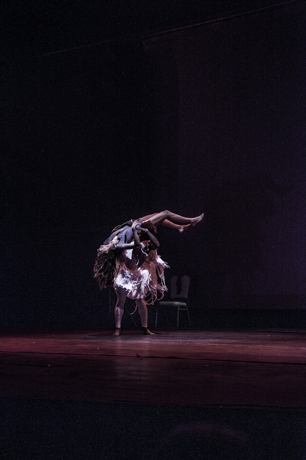 person lifting woman while performing on stage