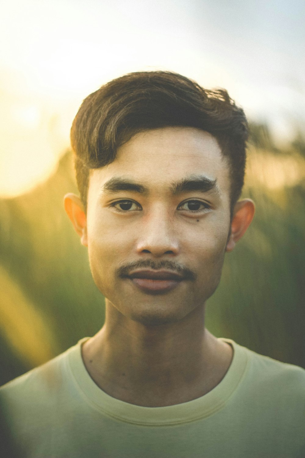 shallow focus photography of man in yellow crew-neck shirt