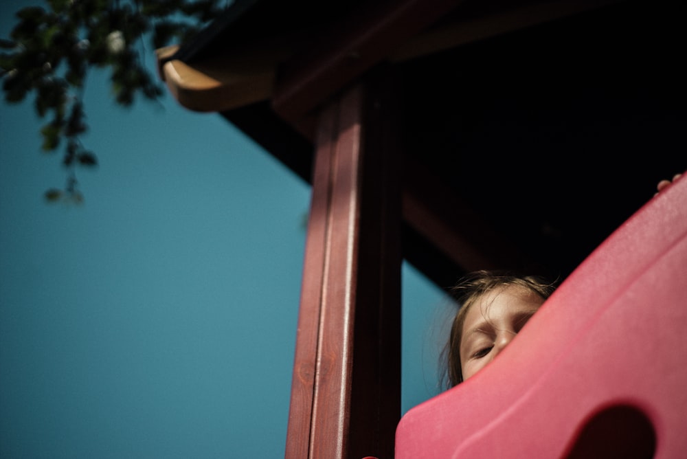 girl playing on play house