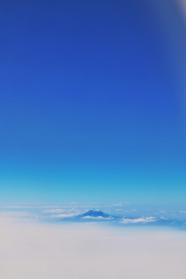 A serene view of a mountain peak under a clear blue sky.