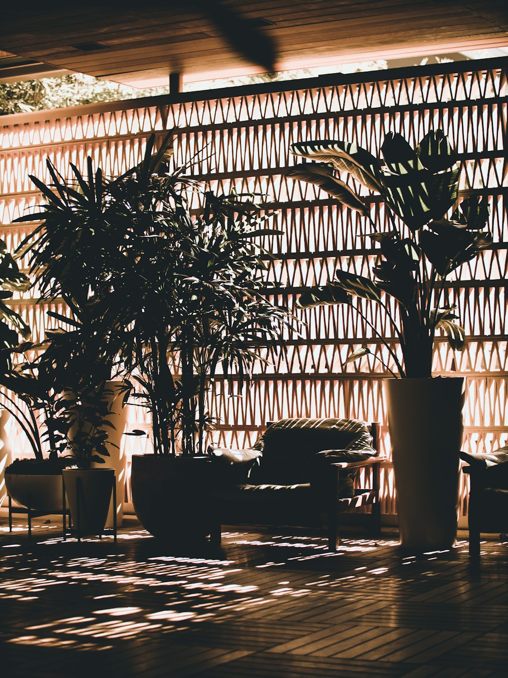 photo of sofa between vases