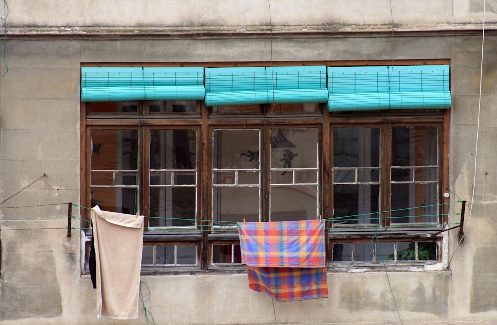 blue and red towel hanging near window