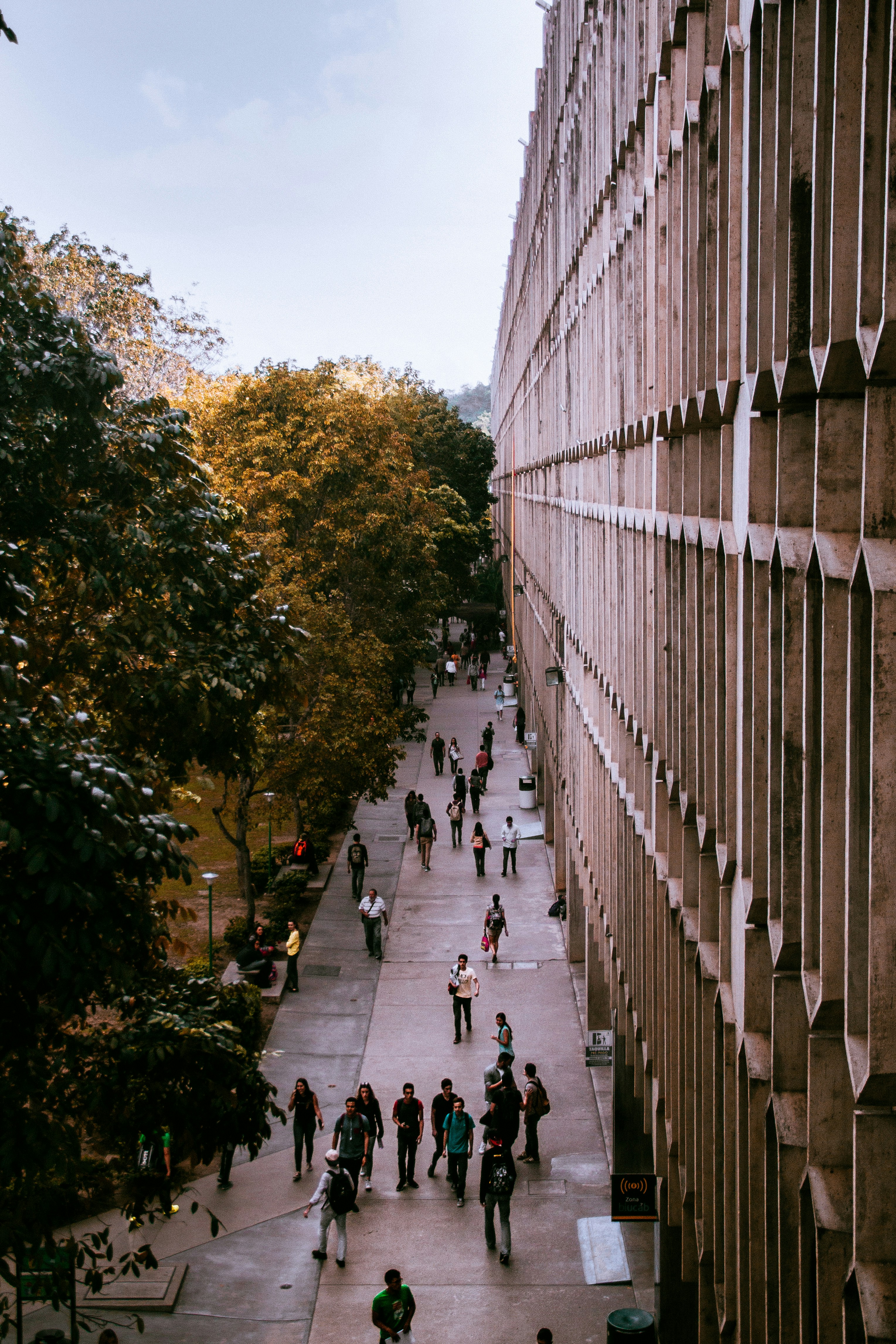 people passing gray building