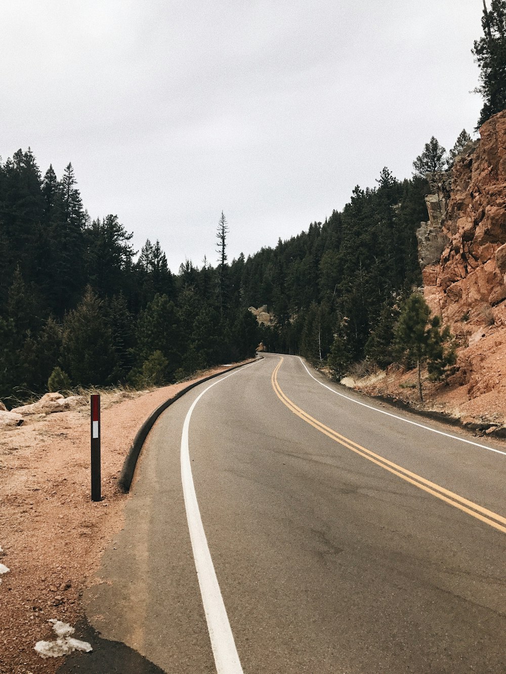 road in mountain with green trees