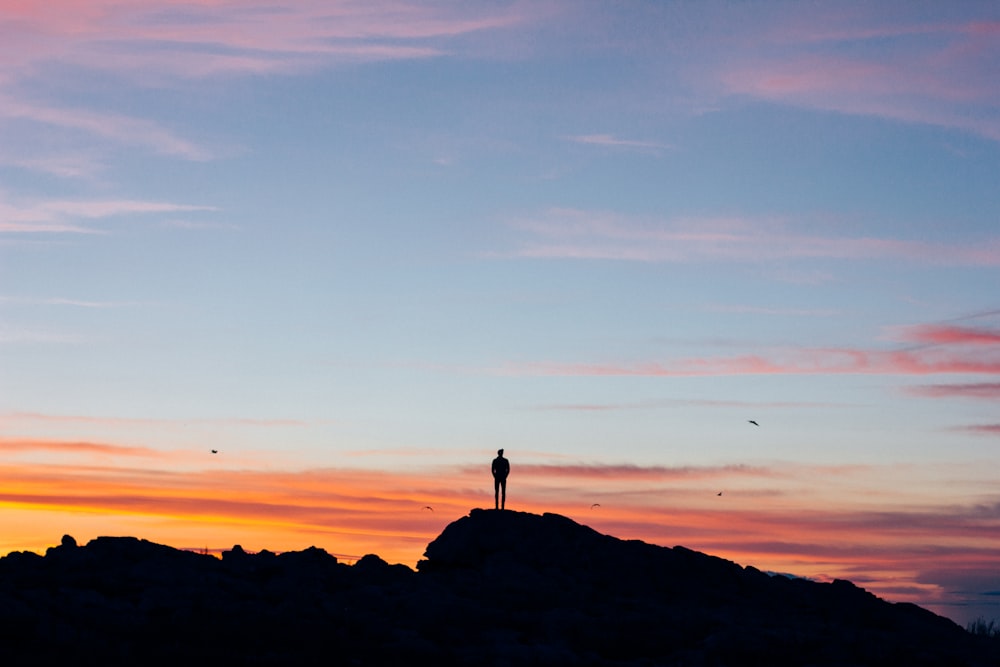 silhouette photography of man on mountain