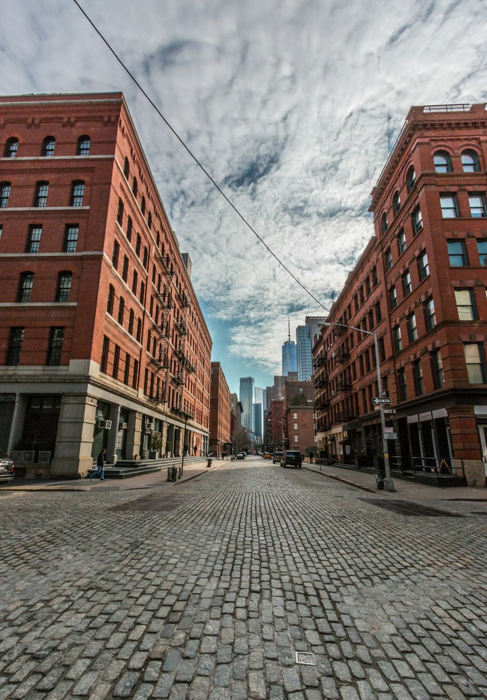 gray street under white clouds during daytime