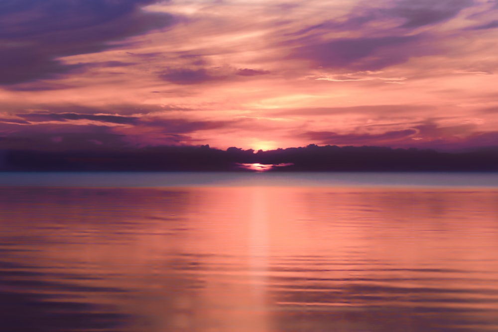 body of water during sunset