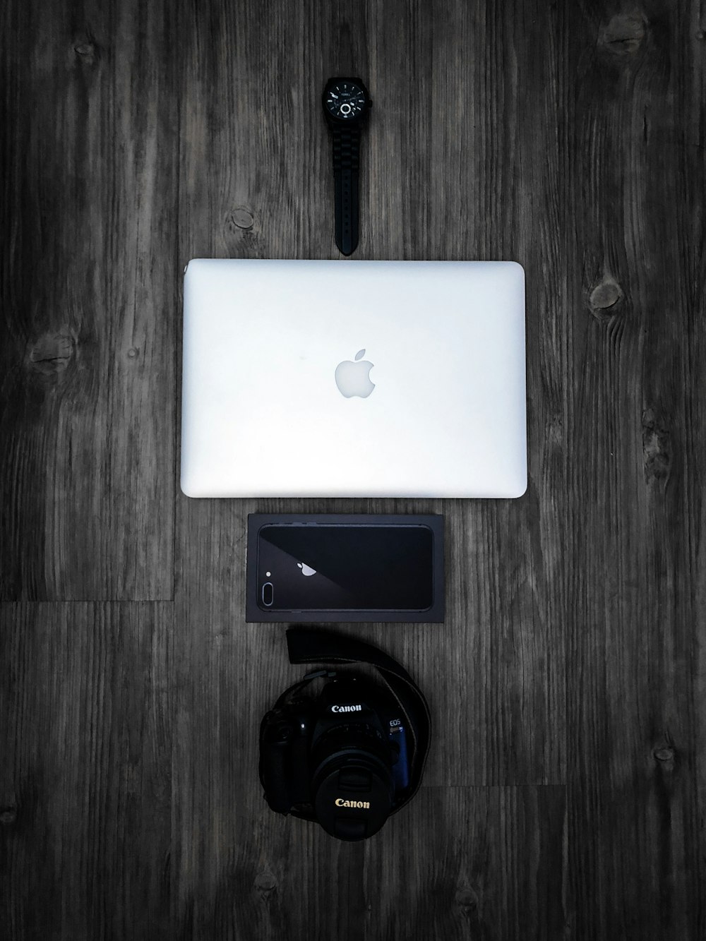 silver Macbook on grey table