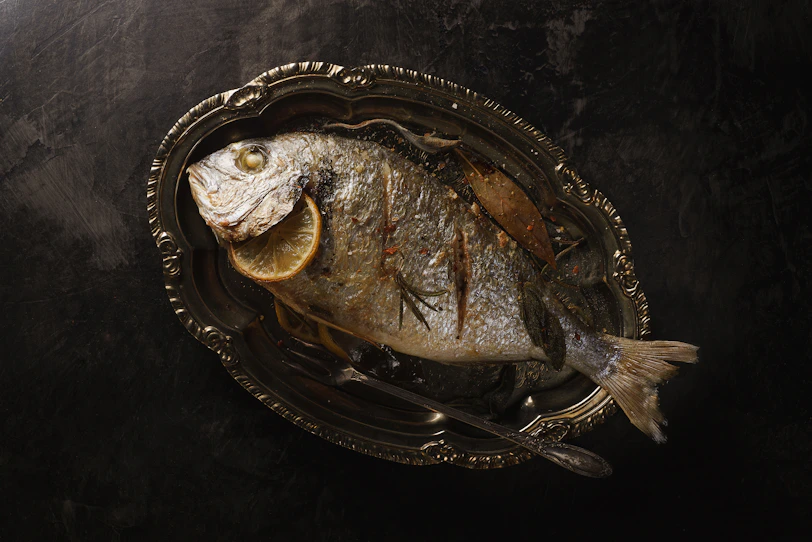 fried fish with lemon in plate