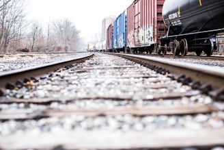 photo of a train rails beside container van