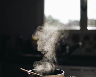 white casserole with gray spoon on black surface